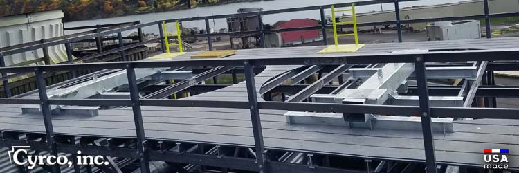 Two mechanical equipment supports for mounting fan gearboxes and motors on top of frp framed and decked new field erected cooling tower. FRP ladder system with hatch doors through FRP fan decking floor panels.