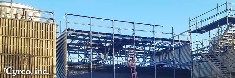 Rebuilt Cooling Tower with FRP Square Tube Strurctual Framing by an Older Unit and Wood Stairtower.